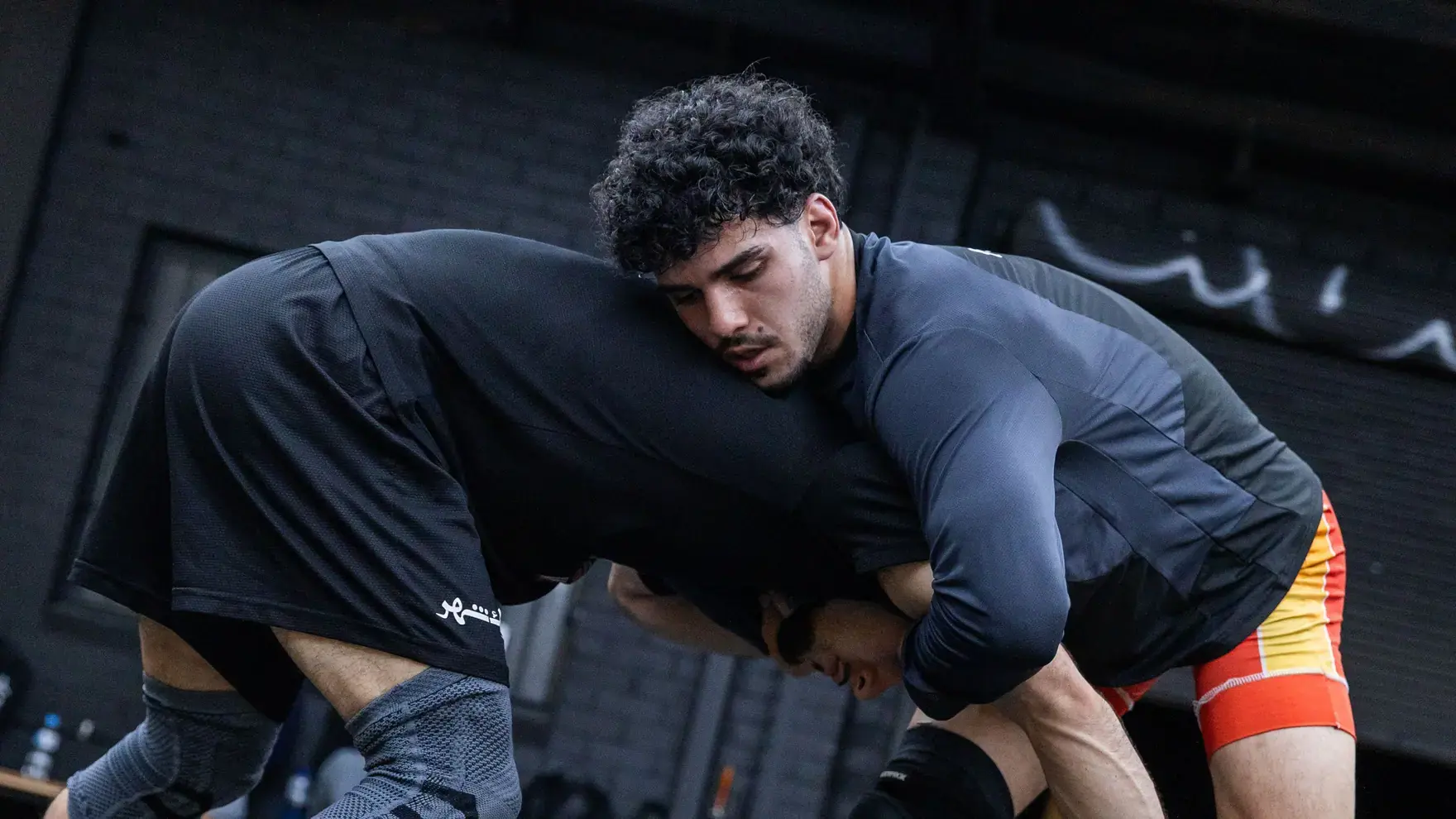 Two members in a wrestling tie-up at Marrickville Martial Arts Club