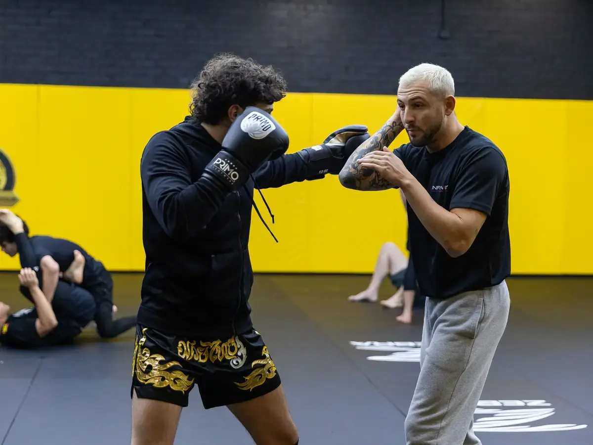 Members working Thai pads during a Muay Thai class