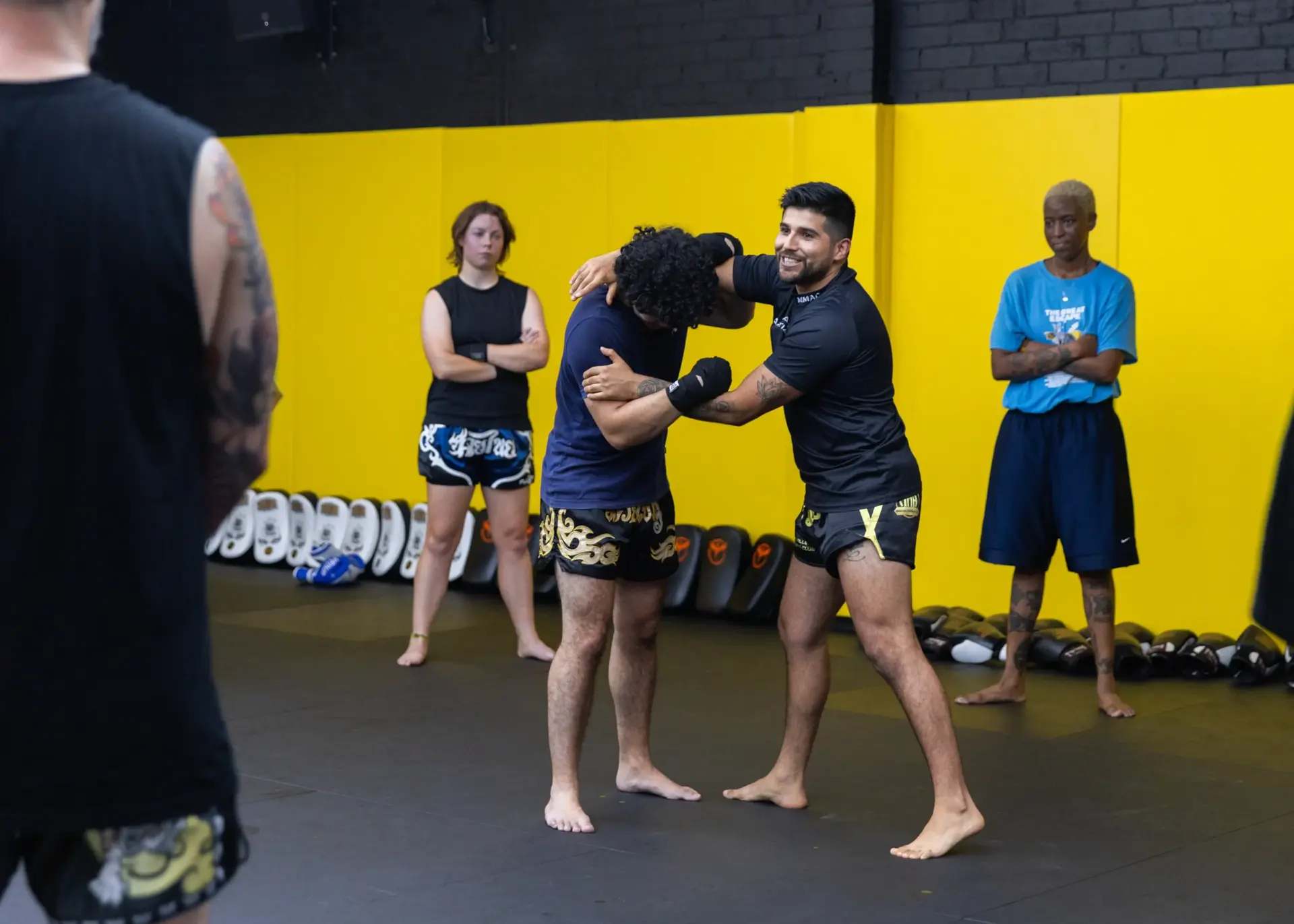 Coach demonstrating a clinch to the class