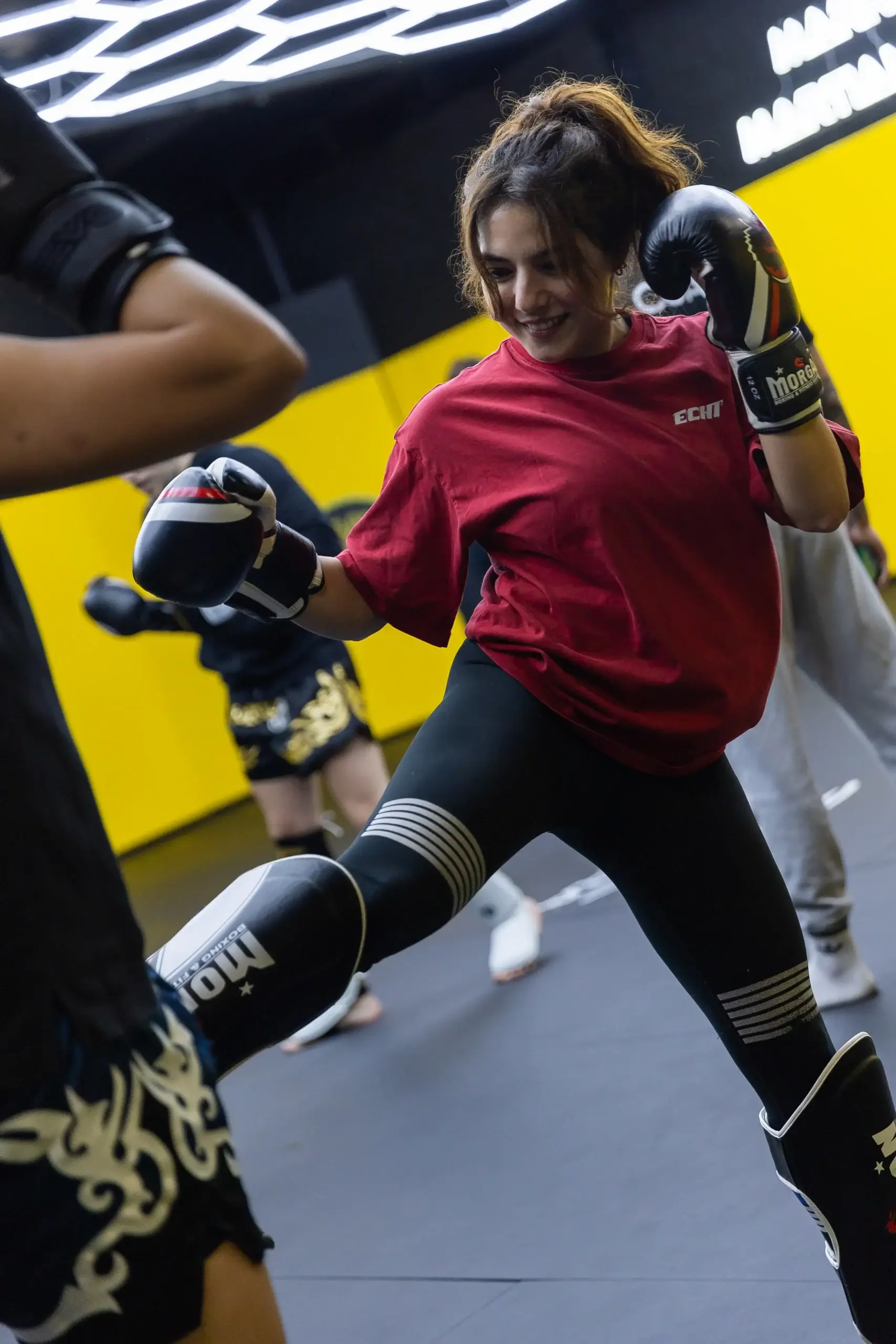 Member throwing a kick during a striking class